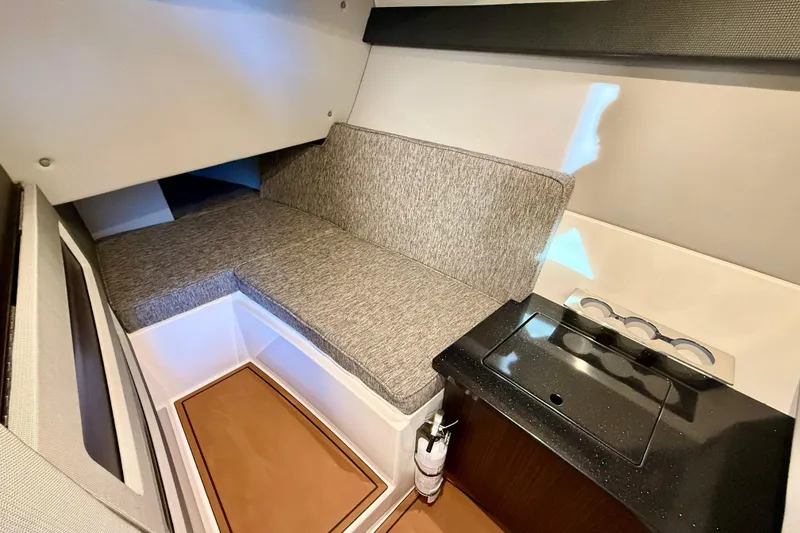 Slide: The Image of Interior cabin of 2025 Cobalt R33 boat with seating and kitchenette. - 18