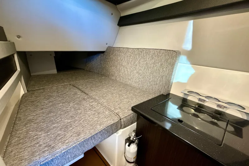 Slide: The Image of 2025 Cobalt R33 interior cabin with cushioned seating and compact kitchenette. - 19