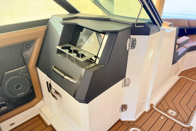 Slide: The Image of Interior of 2025 Cobalt R33 boat featuring sleek design and cup holders. - 23