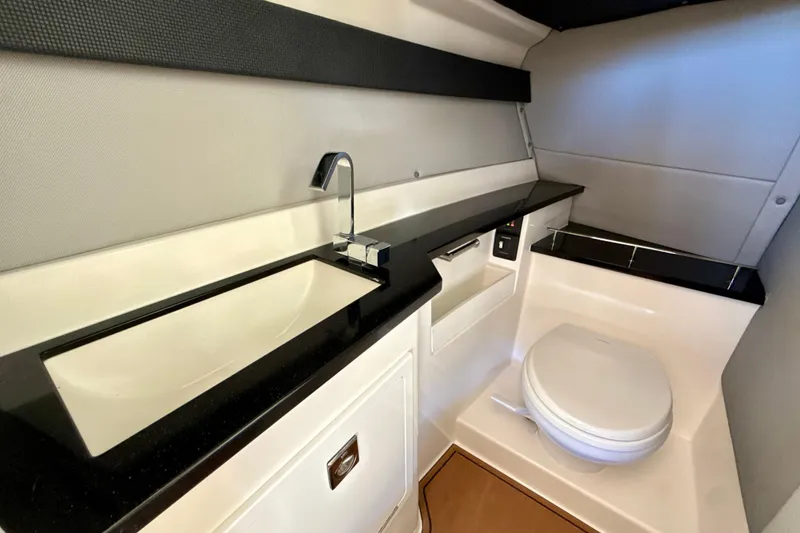 Slide: The Image of Modern bathroom interior in 2025 Cobalt R33 boat, featuring sleek sink and toilet design. - 24