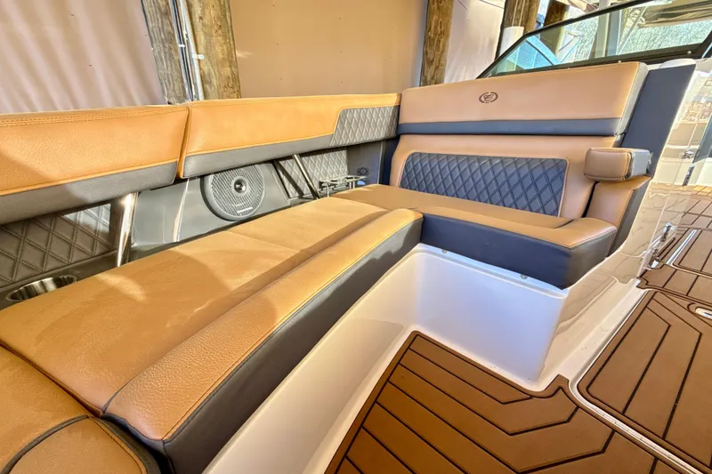 Slide: The Image of Luxurious interior seating of 2025 Cobalt R33 boat with tan and black upholstery. - 27