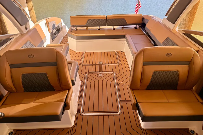 Slide: The Image of Luxurious interior of 2025 Cobalt R33 boat with tan leather seating and wood flooring. - 29