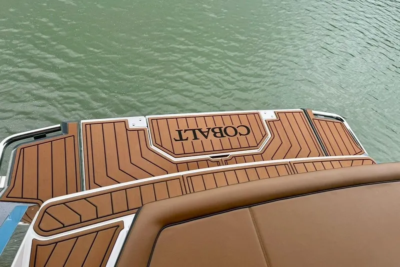 Slide: The Image of 2025 Cobalt R33 boat swim platform with teak-style decking on water. - 36