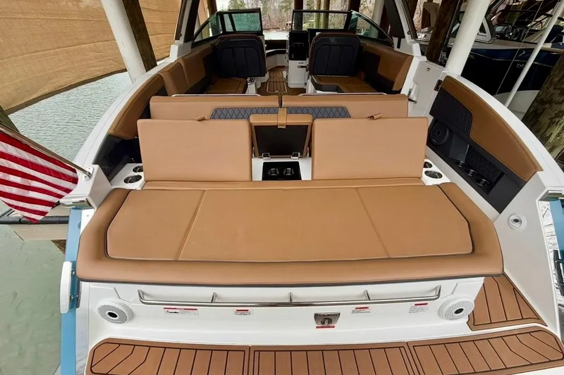 Slide: The Image of 2025 Cobalt R33 boat interior with tan seating and American flag. - 38