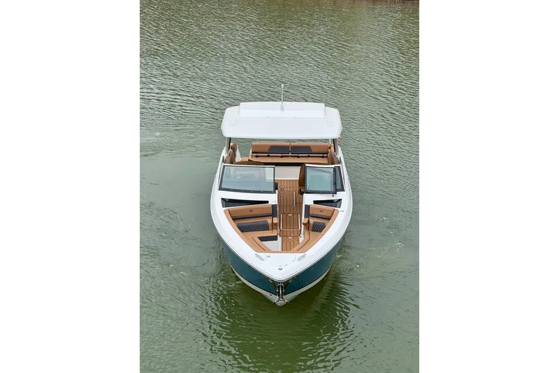 Slide: The Image of 2025 Cobalt R33 boat on water, featuring sleek design and spacious deck. - 7