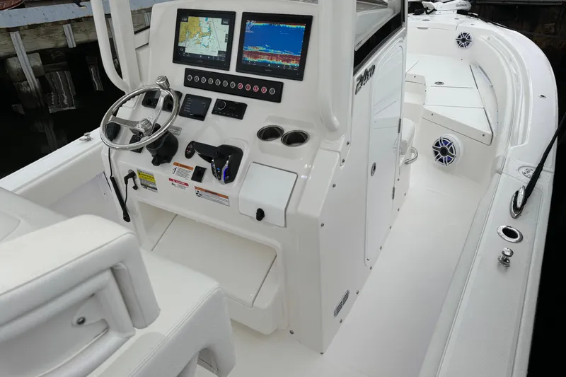 Slide: The Image of 2025 Regulator 24XO boat cockpit with advanced navigation displays and sleek white interior. - 11