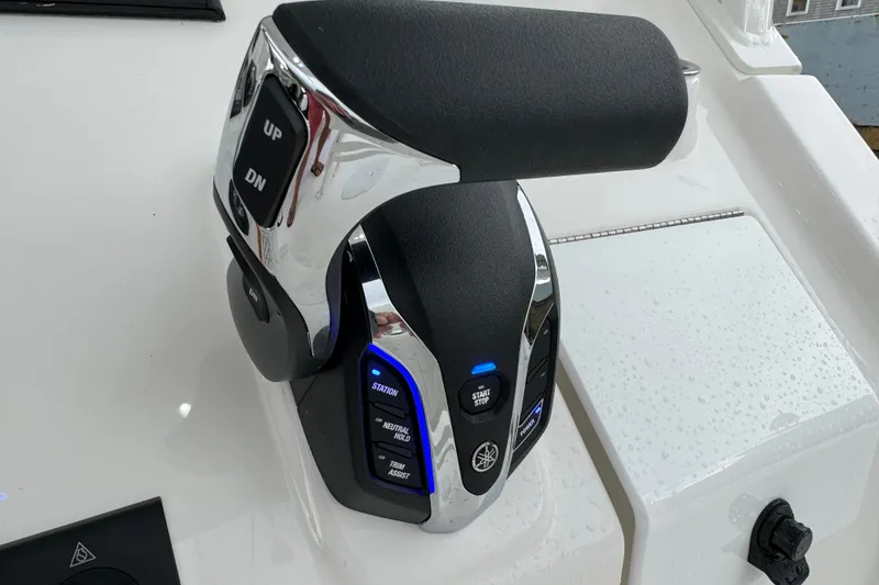 Slide: The Image of 2025 Regulator 24XO boat throttle control with chrome and black finish. - 17