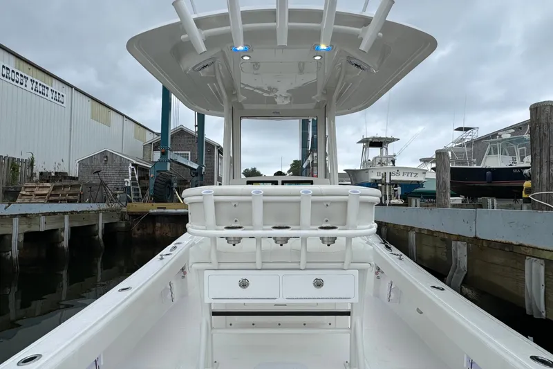Slide: The Image of 2025 Regulator 24XO boat docked at Crosby Yacht Yard, showcasing sleek design and spacious deck. - 9