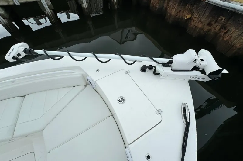 Slide: The Image of 2025 Regulator 24XO boat with Garmin trolling motor at dock. - 23