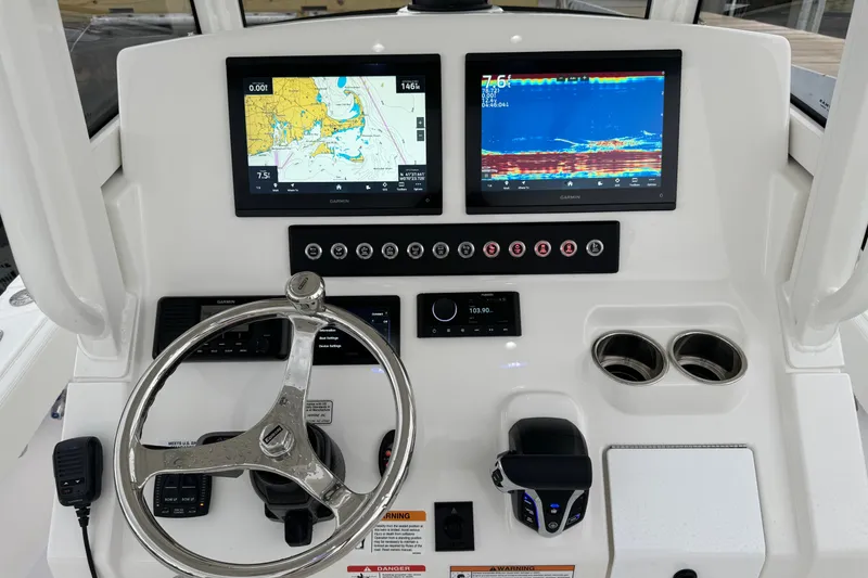 Slide: The Image of 2025 Regulator 24XO boat dashboard with dual Garmin displays and steering wheel. - 10