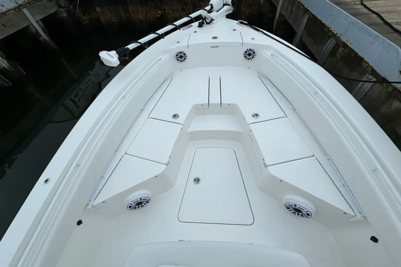 Slide: The Image of 2025 Regulator 24XO boat deck with storage compartments and speakers. - 19