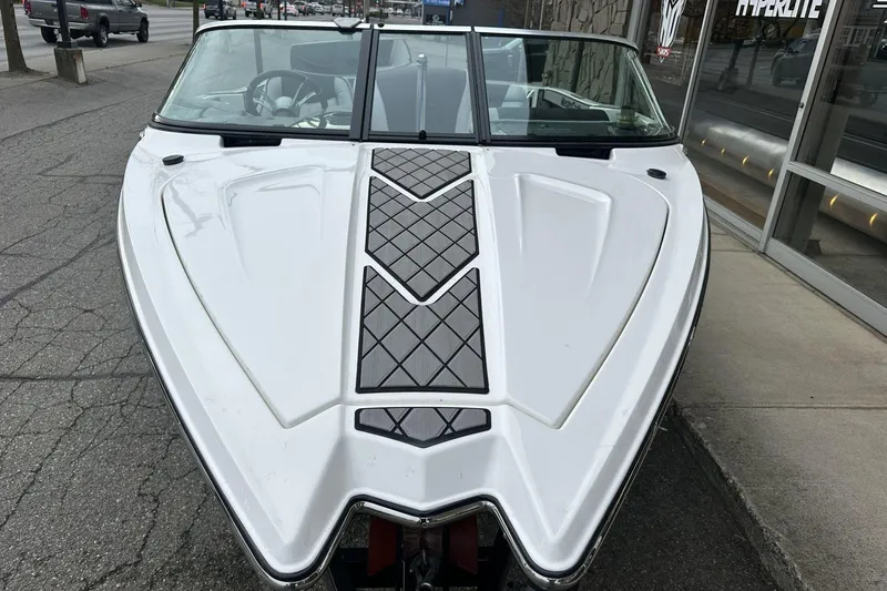 Slide: The Image of 2015 MasterCraft ProStar boat, white exterior, parked on urban street. - 4