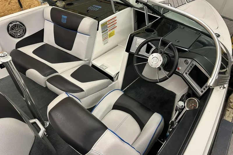Slide: The Image of 2015 MasterCraft ProStar interior with black and white seating, steering wheel, and dashboard controls. - 5
