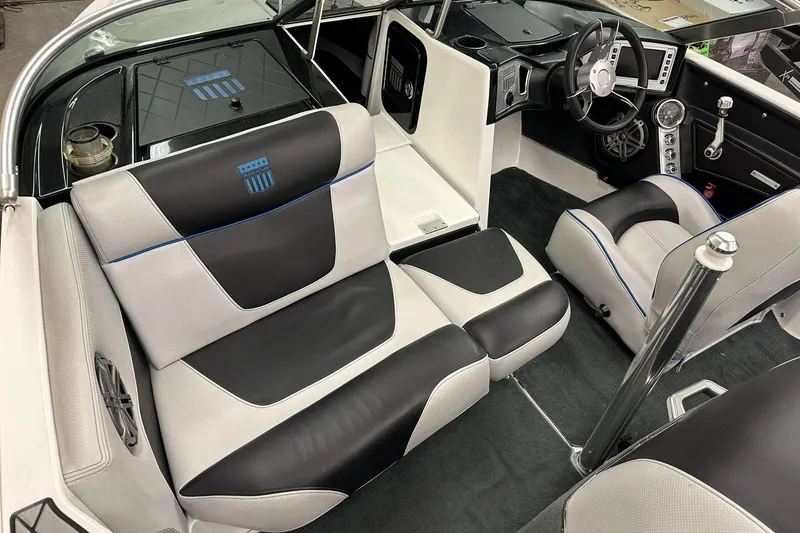 Slide: The Image of 2015 MasterCraft ProStar interior with black and white seating, modern dashboard, and steering wheel. - 6