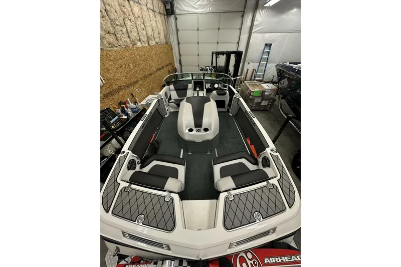 Slide: The Image of 2015 MasterCraft ProStar boat interior in a garage, featuring sleek seating and modern design. - 8