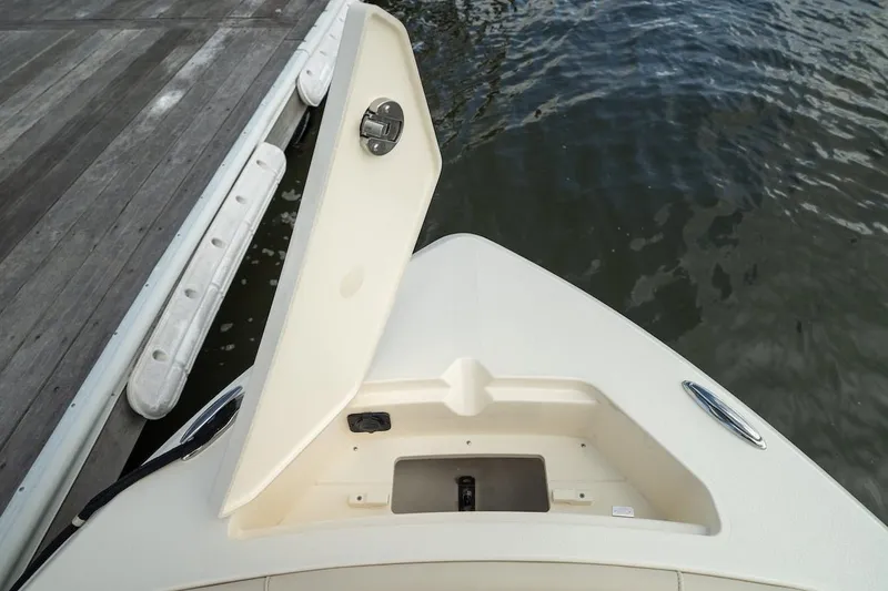 Slide: The Image of Bow view of 2026 Scout 188 Sportfish boat docked by the water. - 15