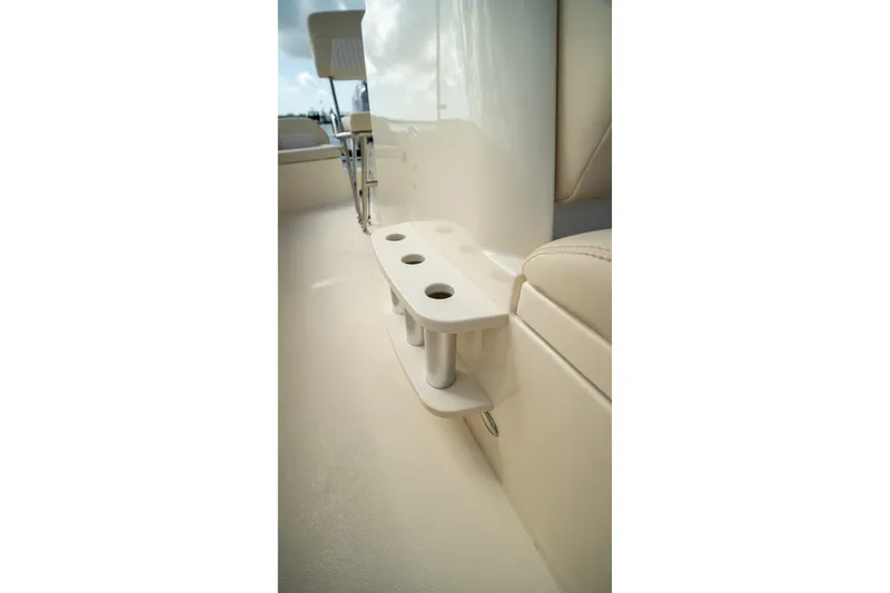 Slide: The Image of 2026 Scout 188 Sportfish boat interior with rod holders and seating. - 18