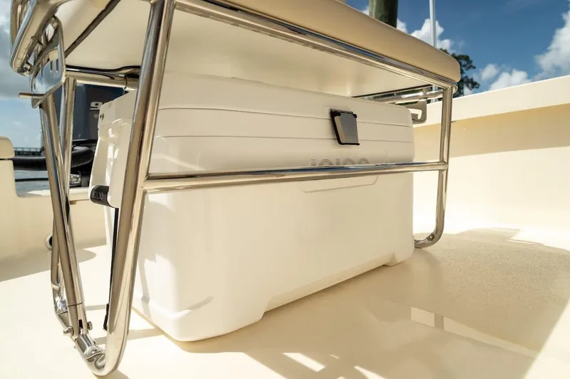 Slide: The Image of 2026 Scout 188 Sportfish boat with cooler under seat, sunny day. - 19