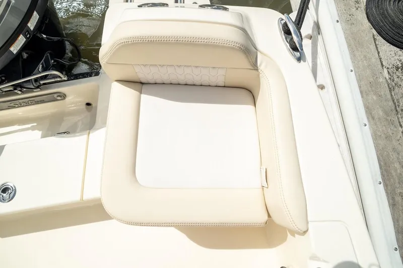 Slide: The Image of 2026 Scout 188 Sportfish boat seat, beige upholstery, docked by water. - 21