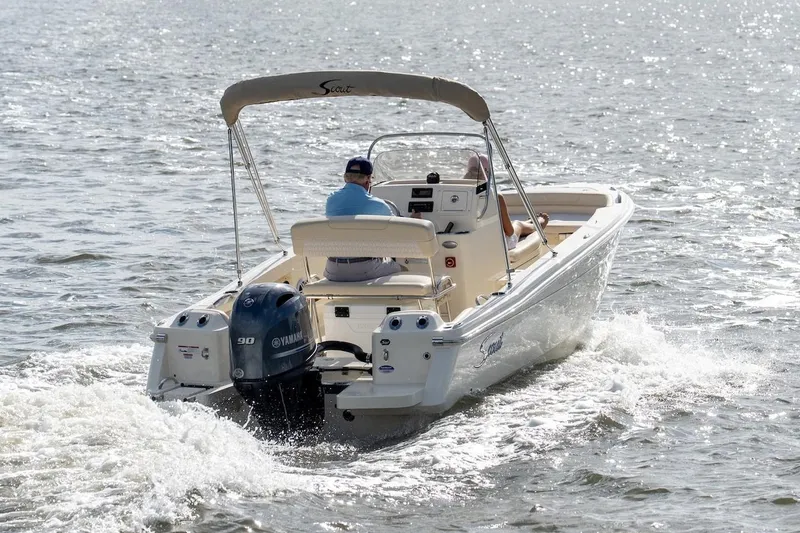 Slide: The Image of 2026 Scout 188 Sportfish boat cruising on open water, featuring Yamaha outboard motor. - 27