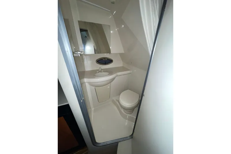 Slide: The Image of Compact bathroom in a 2007 Bayliner 325 boat, featuring a toilet and sink. - 22