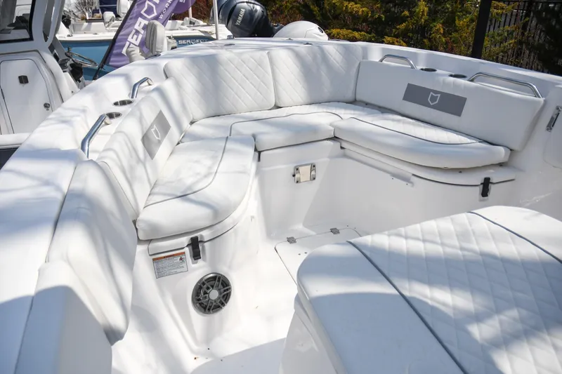 Slide: The Image of 2026 Sea Fox 268 Commander boat interior with white cushioned seating and stainless steel accents. - 2