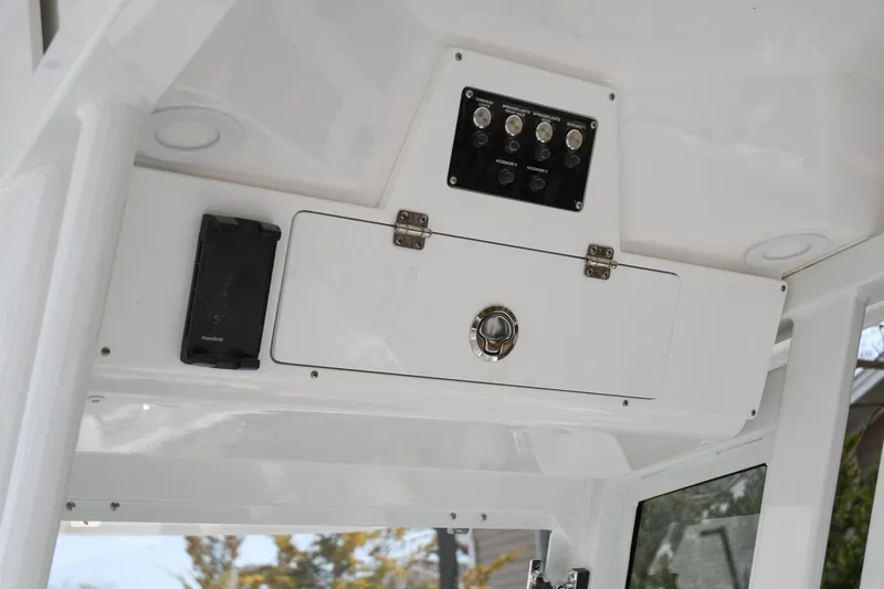 Slide: The Image of 2026 Sea Fox 268 Commander boat console with control panel and storage compartment. - 11