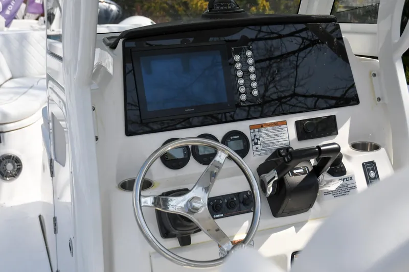 Slide: The Image of 2026 Sea Fox 268 Commander boat dashboard with steering wheel and navigation controls. - 10