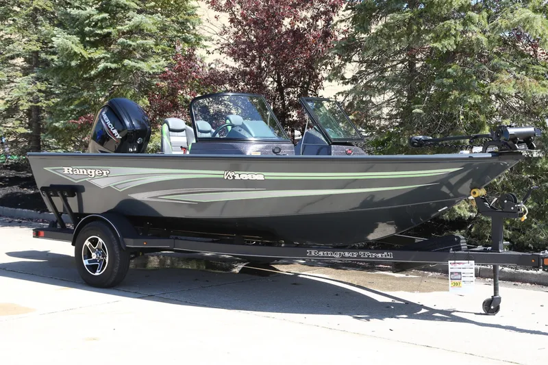 The Image of 2024 Ranger VS1682SC Angler boat on trailer, parked outdoors with trees in background. - 0