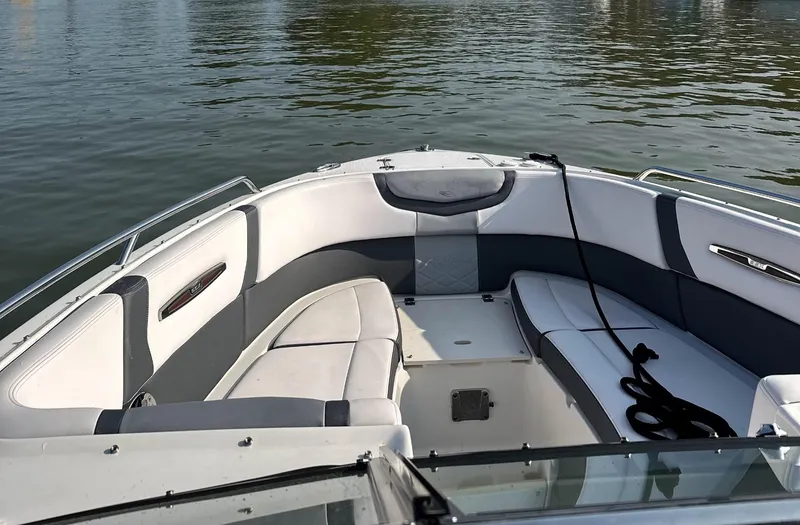 Slide: The Image of 2017 Chaparral 287 SSX boat interior with cushioned seating on calm water. - 6