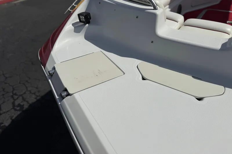 Slide: The Image of 2000 Godfrey 248 Fundeck boat deck with white seating and storage compartments. - 10