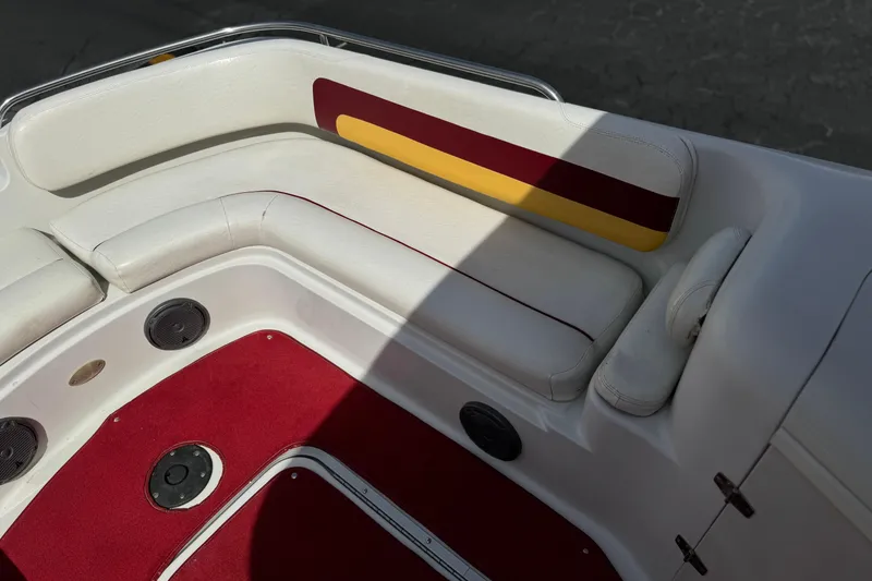 Slide: The Image of Interior seating of a 2000 Godfrey 248 Fundeck boat with red and yellow accents. - 15