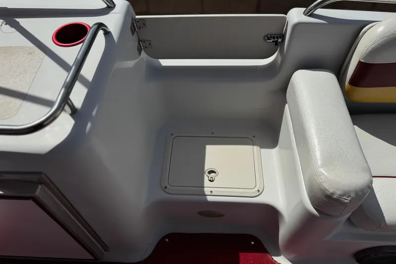 Slide: The Image of Interior view of a 2000 Godfrey 248 Fundeck boat, featuring seating and storage compartment. - 17