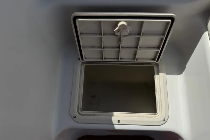 Slide: The Image of Open storage compartment on a 2000 Godfrey 248 Fundeck boat. - 18