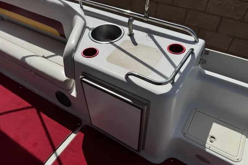 Slide: The Image of Interior of a 2000 Godfrey 248 Fundeck boat with sink and seating area. - 19