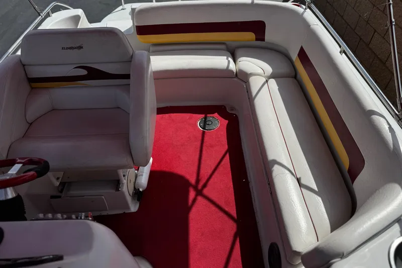 Slide: The Image of Interior of 2000 Godfrey 248 Fundeck boat with red carpet and white seating. - 22