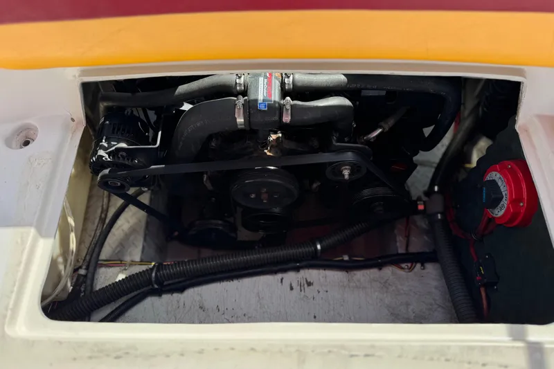 Slide: The Image of Engine compartment of a 2000 Godfrey 248 Fundeck boat, showing belts and hoses. - 26