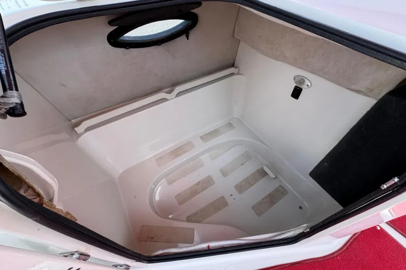 Slide: The Image of Interior cabin of a 2000 Godfrey 248 Fundeck boat, featuring a compact, clean space. - 30