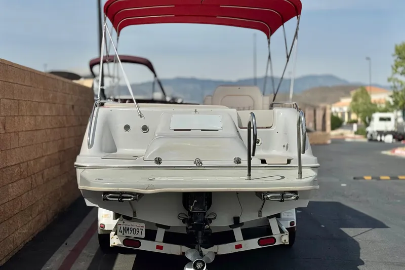 Slide: The Image of Rear view of a 2000 Godfrey 248 Fundeck boat with red canopy. - 4