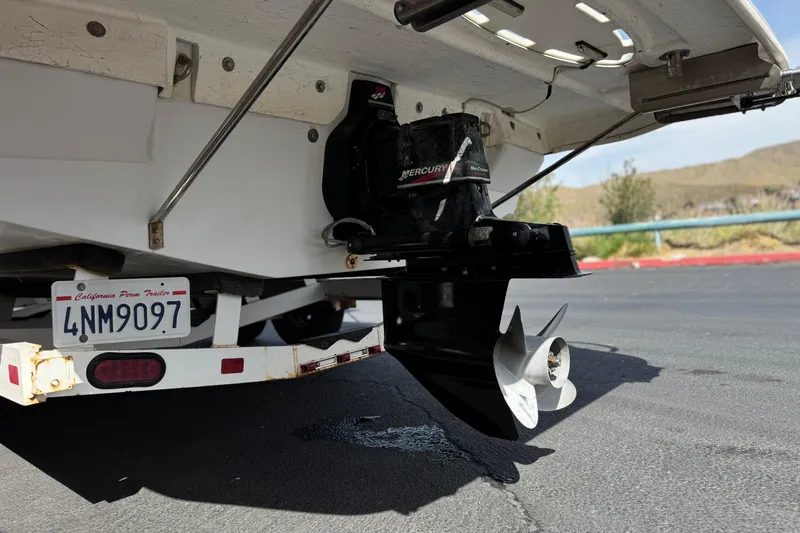 Slide: The Image of Rear view of a 2000 Godfrey 248 Fundeck boat with Mercury outboard motor. - 8