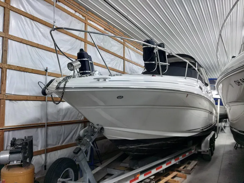 Slide: The Image of 2005 Sea Ray 280 Sundancer boat in indoor storage on trailer. - 11
