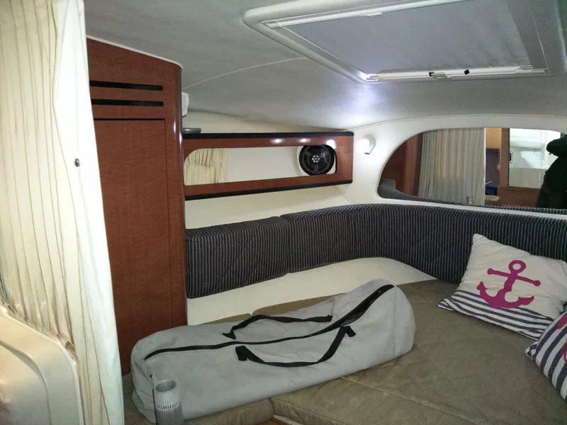 Slide: The Image of Interior of 2005 Sea Ray 280 Sundancer with cozy seating and nautical decor. - 2