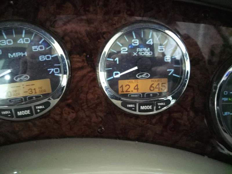 Slide: The Image of Close-up of 2005 Sea Ray 280 Sundancer dashboard gauges displaying RPM, volts, and engine hours. - 4