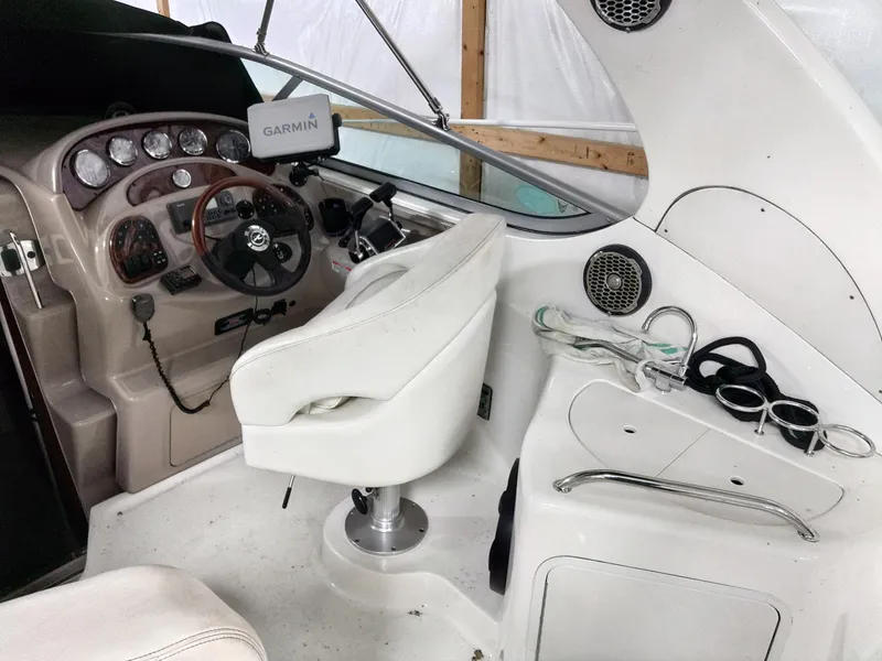 Slide: The Image of 2005 Sea Ray 280 Sundancer cockpit with Garmin navigation system and white seating. - 6