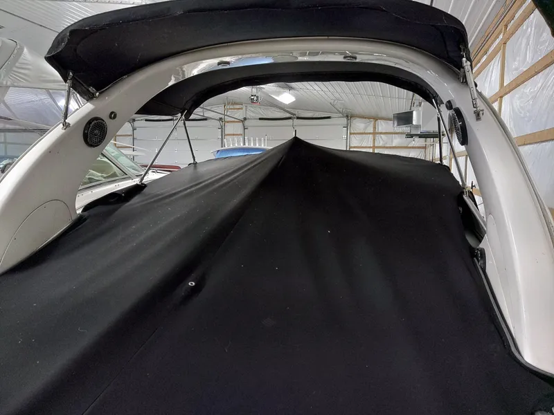 Slide: The Image of 2005 Sea Ray 280 Sundancer with black cover in storage. - 7