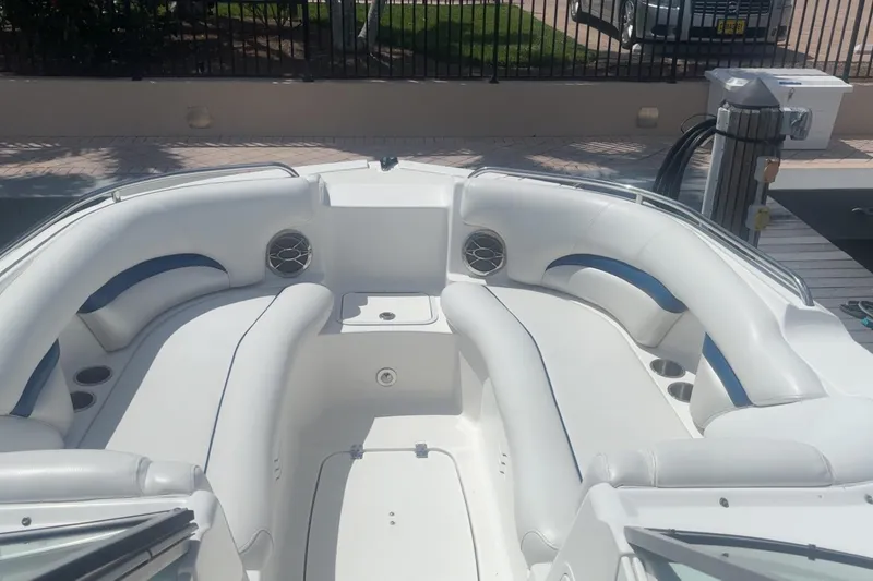 The Image of 2013 Hurricane SunDeck 2400 OB boat interior with white seating and blue accents. - 6