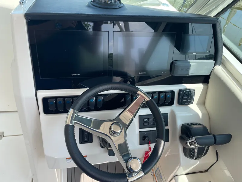 Slide: The Image of 2023 Sailfish 276 DC helm with Garmin displays and controls. - 5