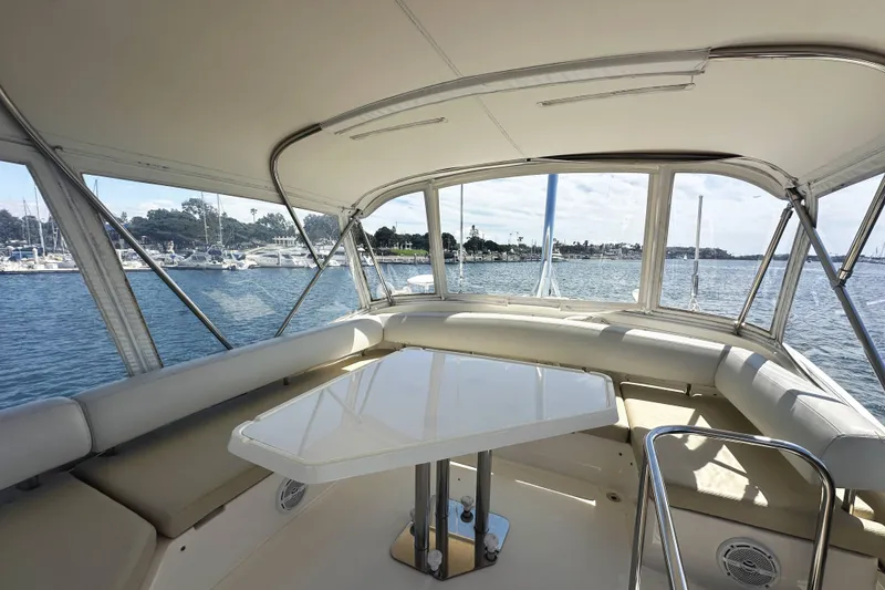 Slide: The Image of Interior view of 2007 Azimut 43 yacht with seating and table, overlooking marina. - 12