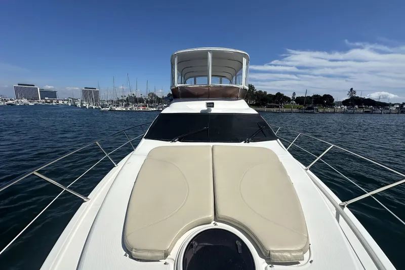 Slide: The Image of 2007 Azimut 43 yacht on water, marina and buildings in background. - 15