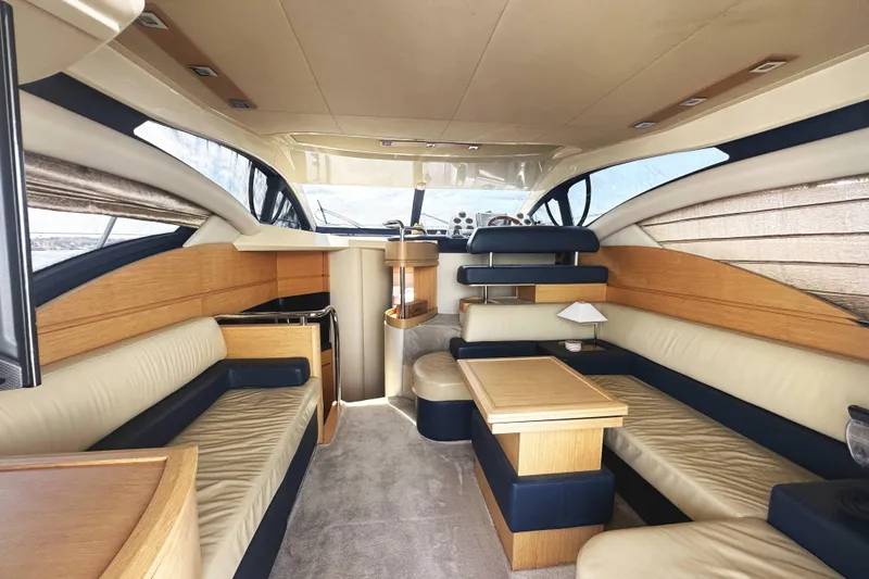 Slide: The Image of Luxurious interior of a 2007 Azimut 43 yacht with elegant seating and wooden accents. - 17